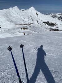 Shadow of people on snow covered mountain