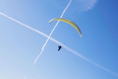 Low angle view of kite flying against blue sky