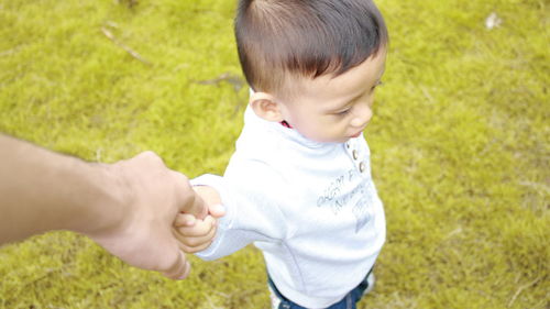 Cute baby girl with hand on grass
