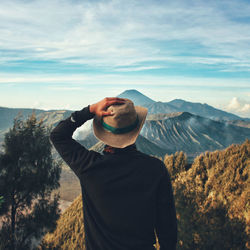 Man standing on mountain against sky