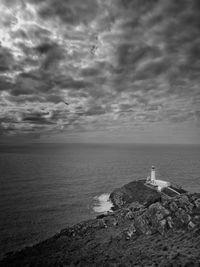 Isolated lighthouse with stormy clouds. south stack. wales uk