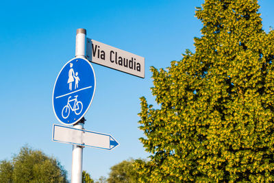 Low angle view of road sign against sky