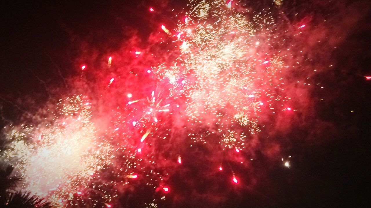 celebration, exploding, firework display, night, lifestyles, firework - man made object, long exposure, arts culture and entertainment, motion, illuminated, sparks, outdoors, low angle view, event, smoke - physical structure, no people, sky, firework