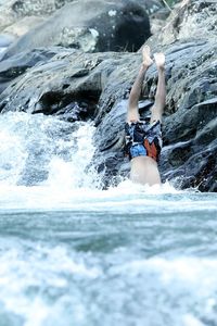 Man swimming jumps into the river