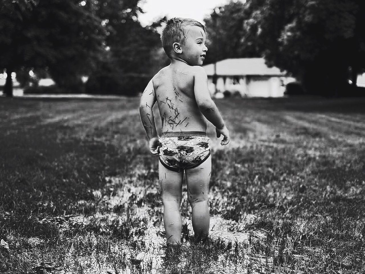 FULL LENGTH OF BOY STANDING ON FIELD