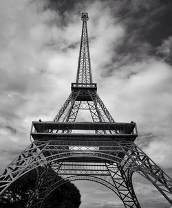 Low angle view of eiffel tower against cloudy sky