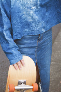 Close-up of woman standing against black background