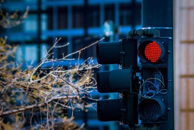 Close-up of a broken and a red street lights