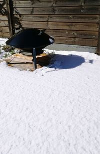 Snow covered field by building