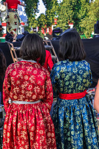 Rear view of women in traditional clothing