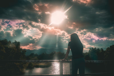 Silhouette man standing against sky during sunset