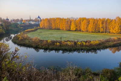 Scenic view of lake by trees against sky during autumn