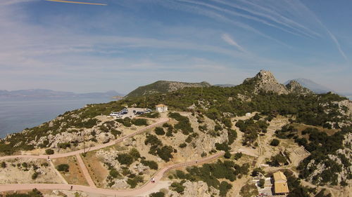 Mountain by sea against sky at perachora