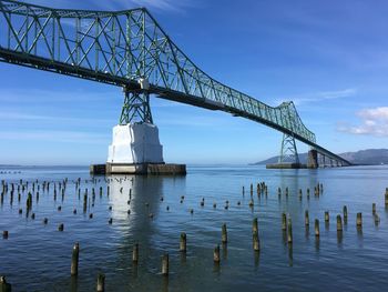 View of bridge over sea against cloudy sky