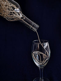 Close-up of beer glass against black background