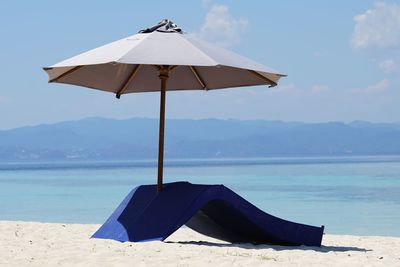 Umbrellas on beach against sky