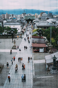 High angle view of people walking on street in city