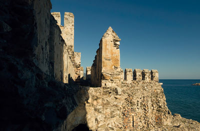 Castle by sea against sky