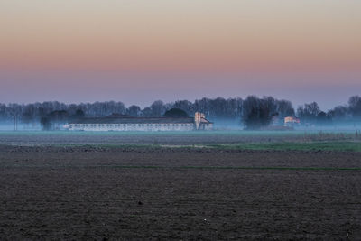 Scenic view of field against sky during sunset