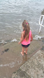 High angle view of girl in front of water