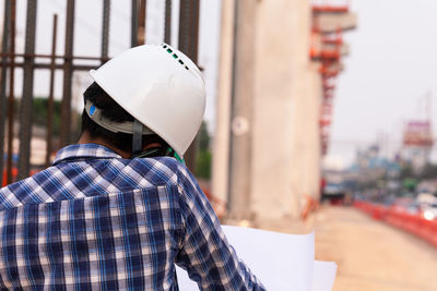 Rear view of man working at construction site