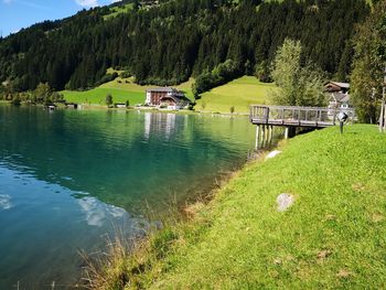 Scenic view of lake by trees on mountain