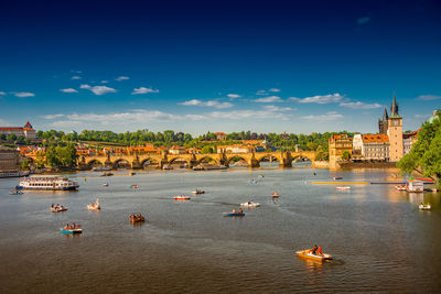 Boats in river with buildings in background