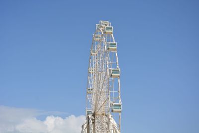 Low angle view of ferries wheel against clear blue sky