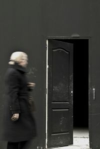 Reflection of man on door