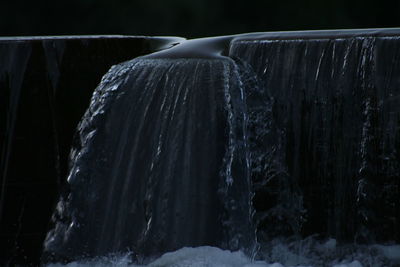 Close-up of frozen waterfall at night