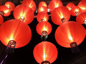 Low angle view of illuminated lanterns hanging at night