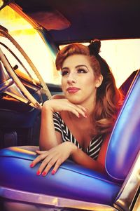 Portrait of young man sitting on seat