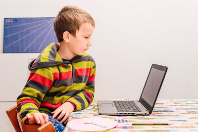 Cute boy looking at laptop