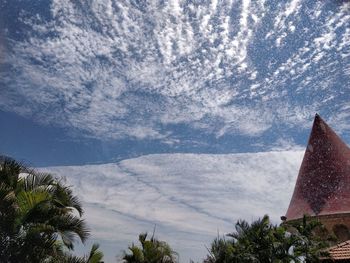 Low angle view of building against cloudy sky