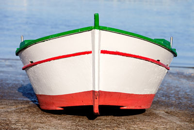 Close-up of red umbrella on beach