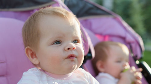 Portrait of cute baby girl looking away