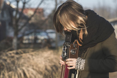 Young woman photographing through camera