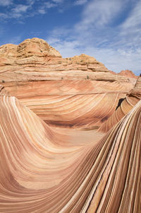 Scenic view of desert against cloudy sky