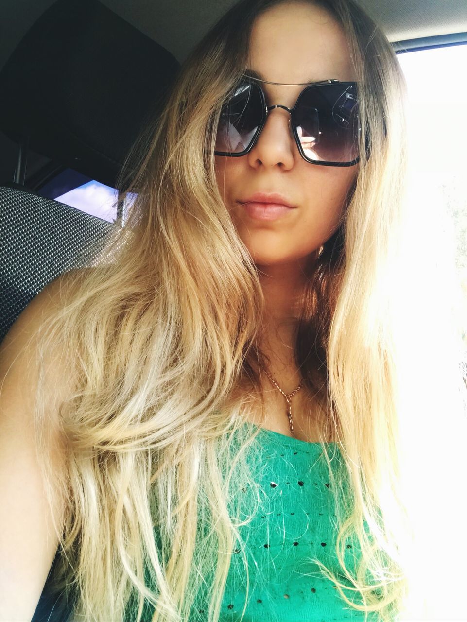 hair, long hair, front view, vehicle interior, one person, real people, young women, hairstyle, car interior, lifestyles, glasses, portrait, young adult, leisure activity, car, mode of transportation, motor vehicle, women, headshot, looking at camera, fashion, beautiful woman, road trip