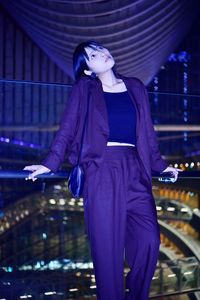 Woman looking up while standing outdoors