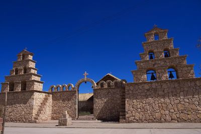 Low angle view of historic building against clear blue sky