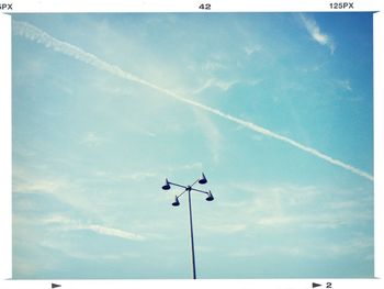 Low angle view of street light against blue sky