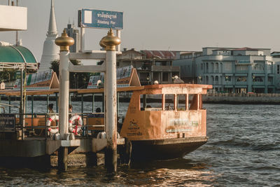 Boats in sea against buildings in city