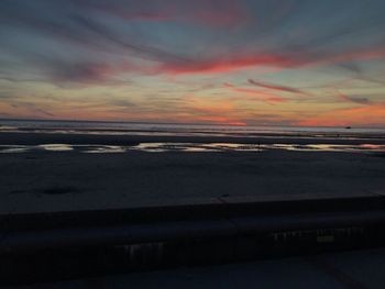 Scenic view of beach against sky during sunset