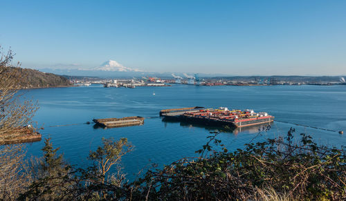 A view of the port of tacoma and mount rainier on a clear day.