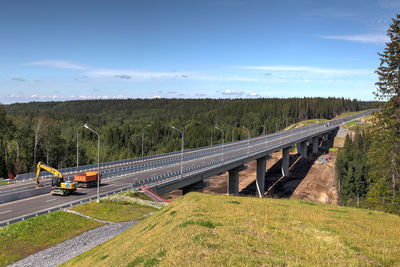 Train on bridge against sky