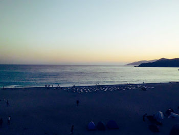 Scenic view of sea against clear sky at sunset