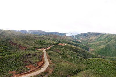 Scenic view of road amidst mountains against sky