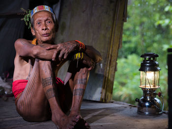 Midsection of woman sitting on table