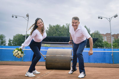 The newlyweds on the tennis court pull skating rink symbolizing a overcoming of family difficulties